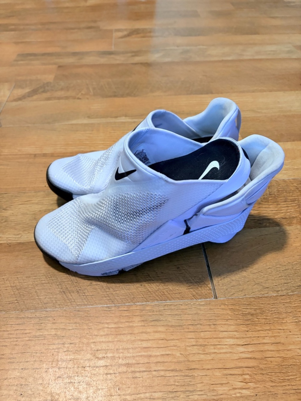 Nike White Slip-On Sneakers with Black Swoosh Accents